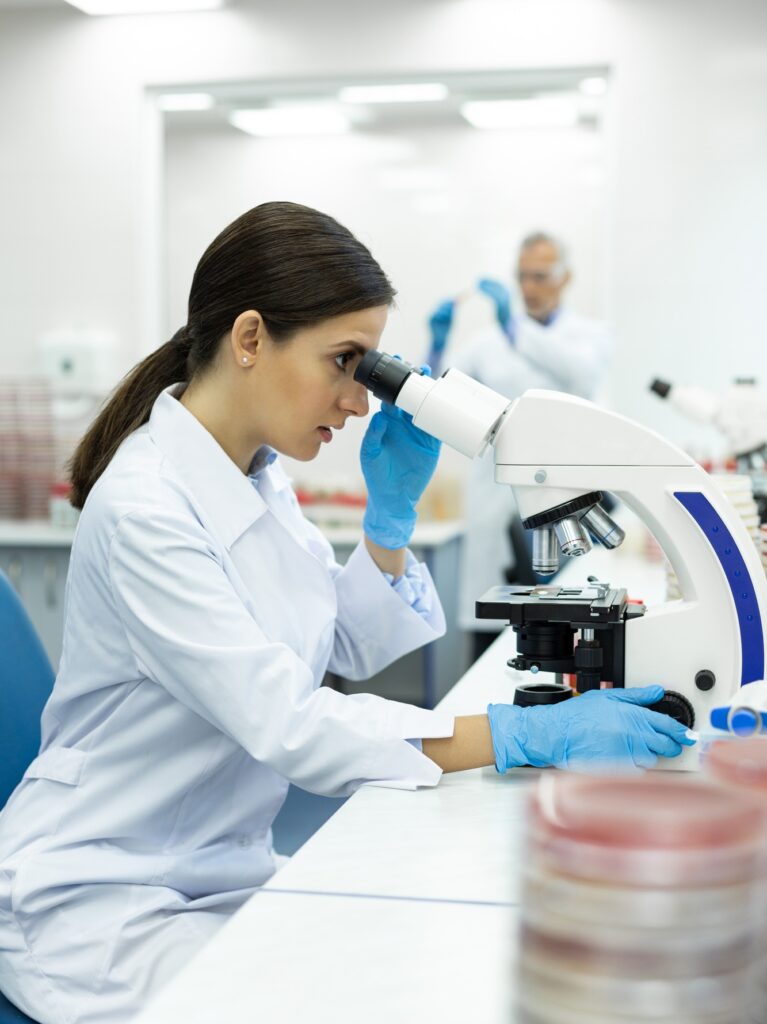 Serious medical worker examining sample of blood